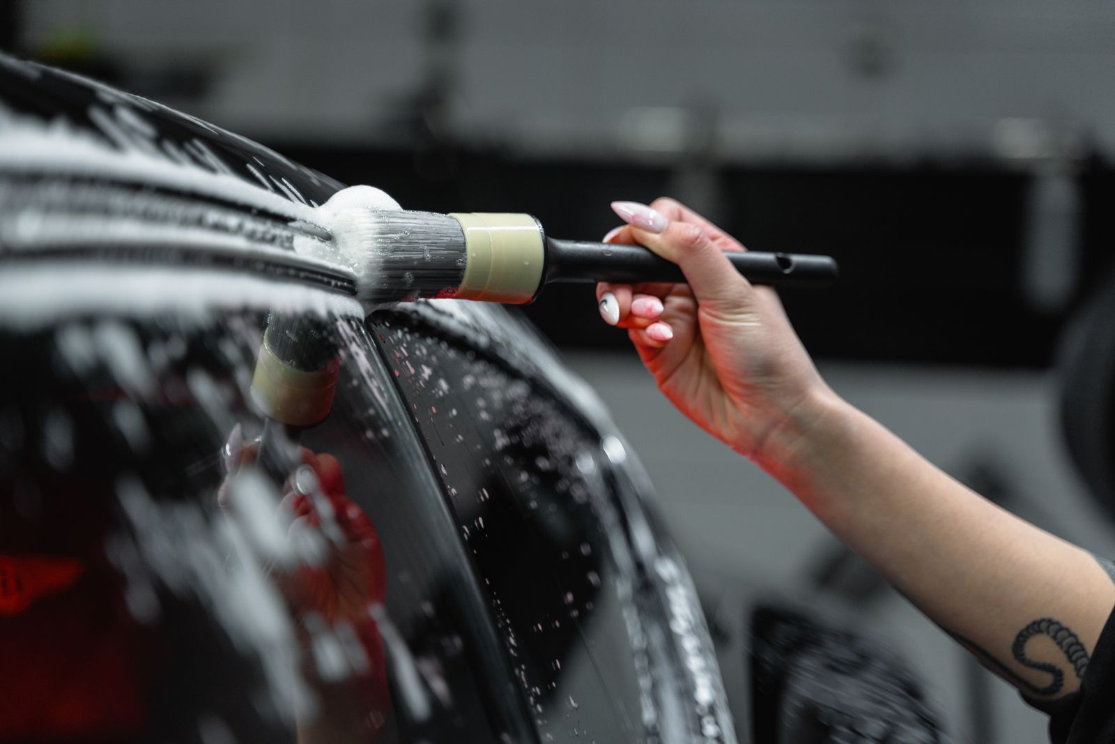 A vehicle covered in foam during an exterior wash